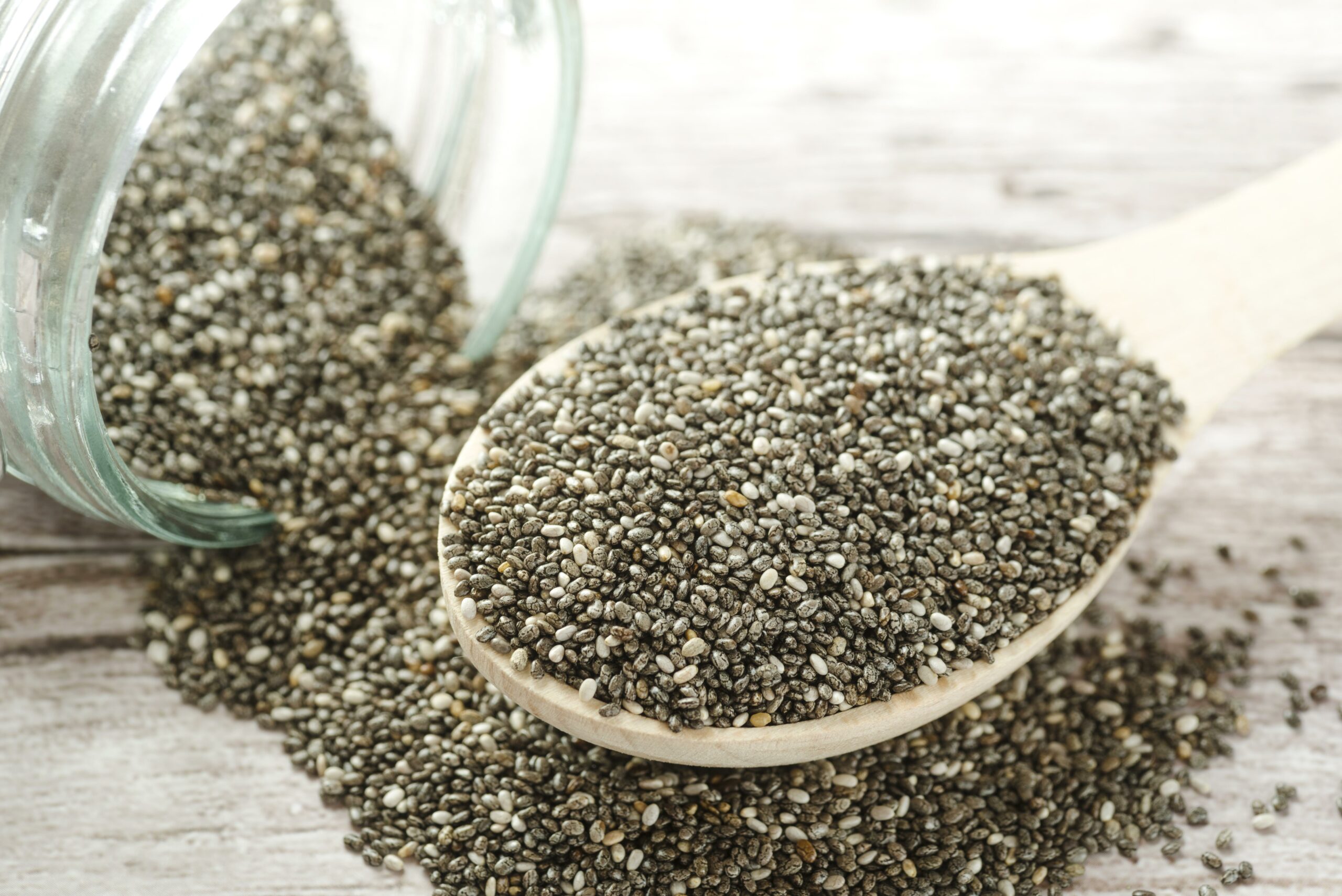 Chia seeds, a vegan egg substitute, delicately arranged on a wooden spoon, offering a nutritious and versatile addition to plant-based cooking